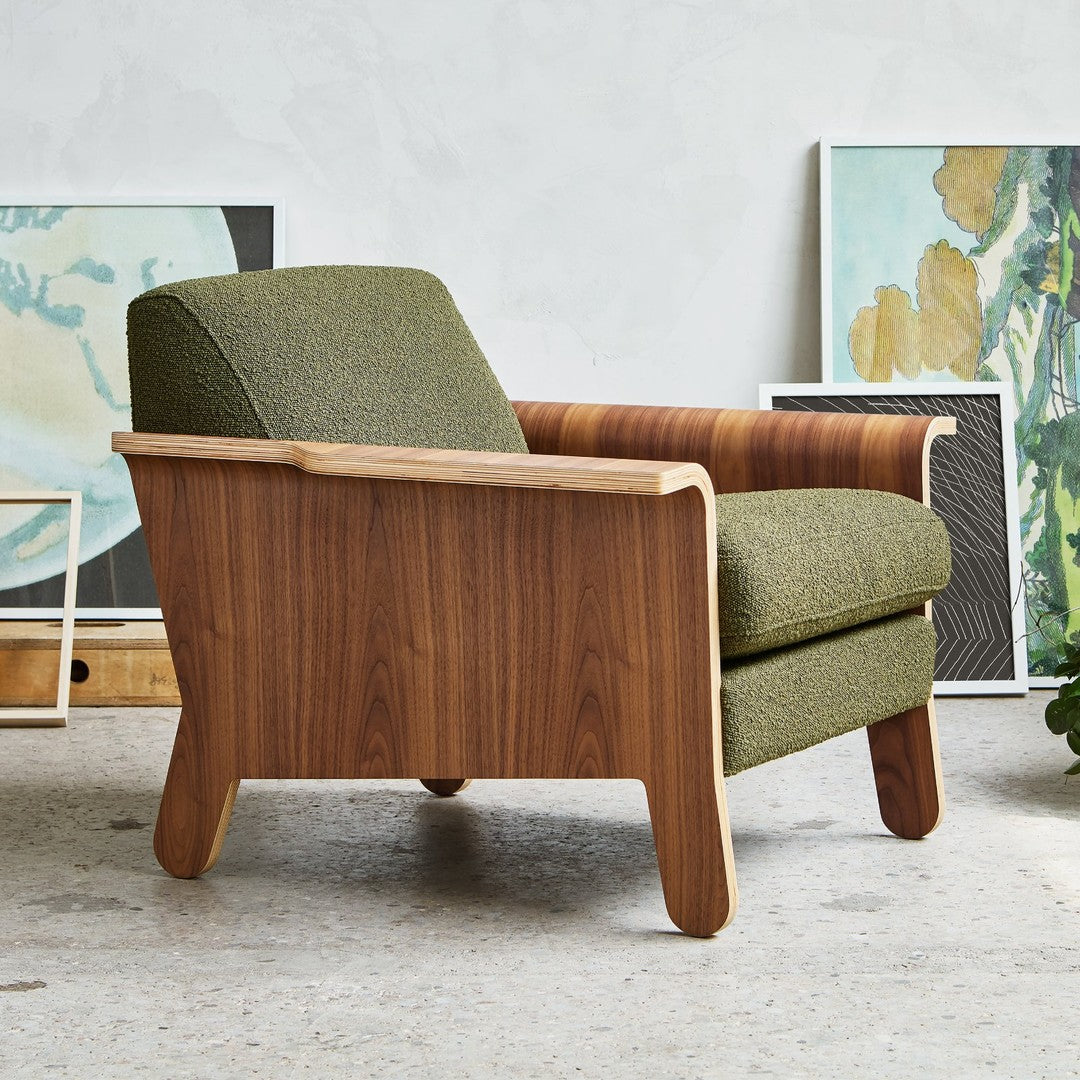 "Modern chair featuring a green textured upholstery and rich wood grain accents for a stylish, earthy appeal."