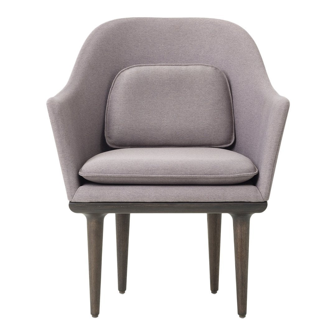 Lavender accent chair with smooth upholstery and dark wooden legs, featuring a minimalist design and soft curves.