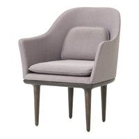 Soft lavender armchair with a minimalist design and subtle texture, featuring wooden legs and a stylish silhouette.