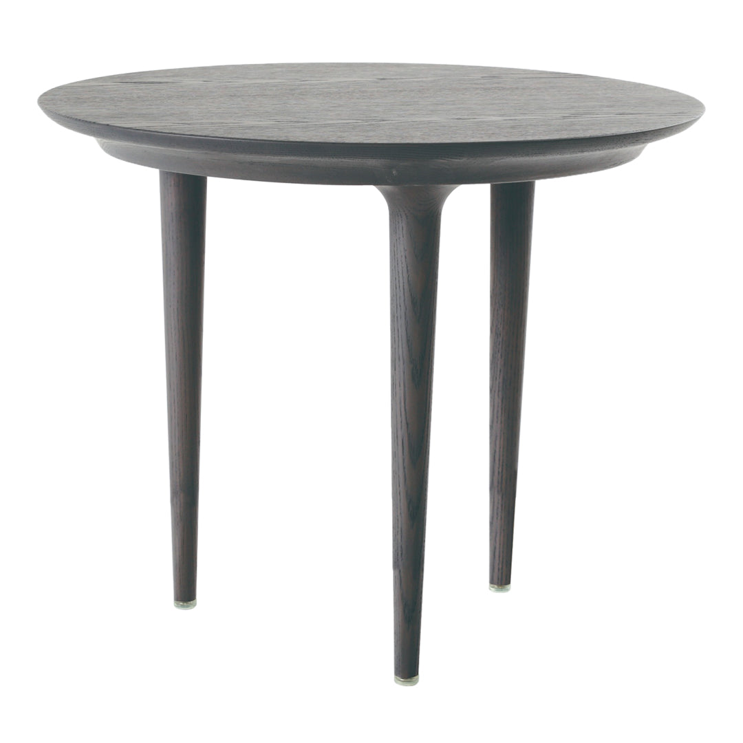Dark round table with a smooth, patterned top and tapered wooden legs, adding a modern touch to any space.