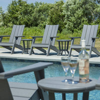 Gray Adirondack chairs by a pool, featuring a minimalist design and smooth finish, complementing the outdoor greenery.