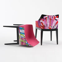 Colorful modern chair featuring vibrant pink and bold graphic patterns in black and multi-colored designs.