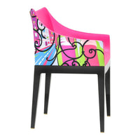 Colorful chair featuring a vibrant pink seat, abstract patterns, and black legs with decorative designs.