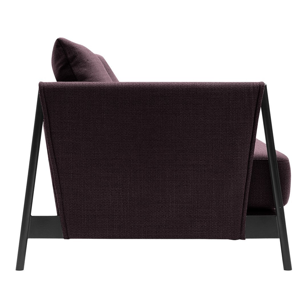 "Modern armchair with a deep purple fabric and sleek black frame, featuring a minimalistic pattern."