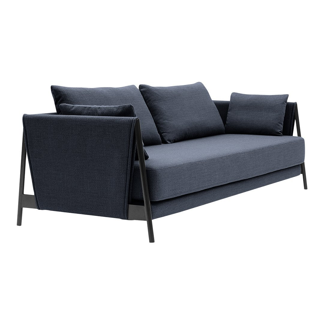 Stylish dark blue sofa with smooth fabric and sleek black frame accents. Ideal for modern interiors.
