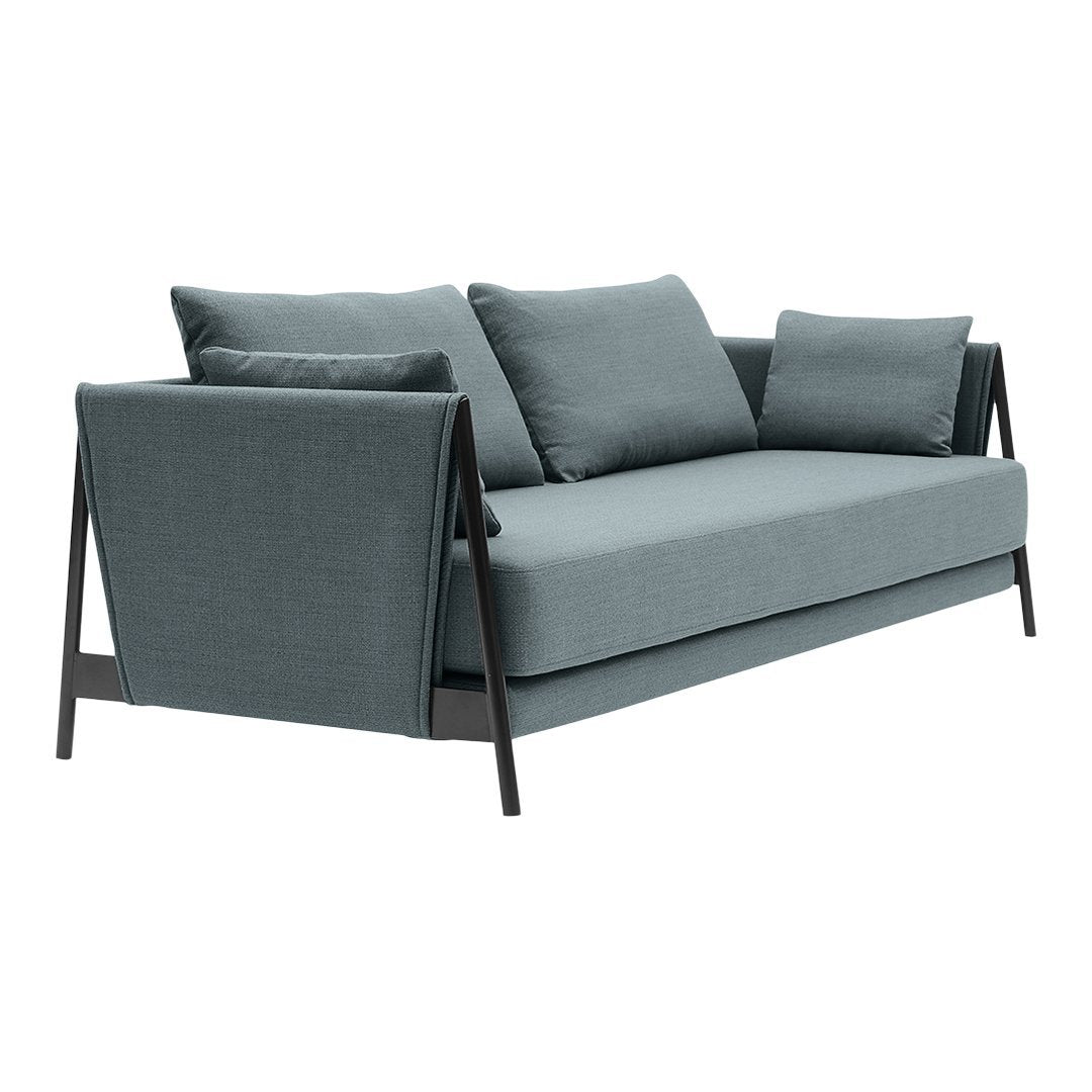 "Modern light blue sofa with texture, featuring dark wood accents and matching cushions for a sleek, stylish look."