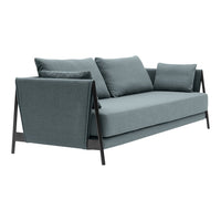 "Modern light blue sofa with texture, featuring dark wood accents and matching cushions for a sleek, stylish look."