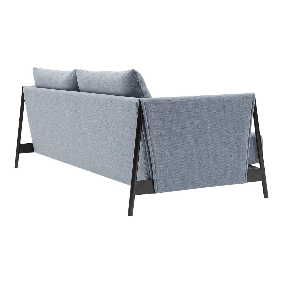 Light blue fabric sofa with simple, modern lines and dark wooden accents. Soft, neutral cushions enhance the design.