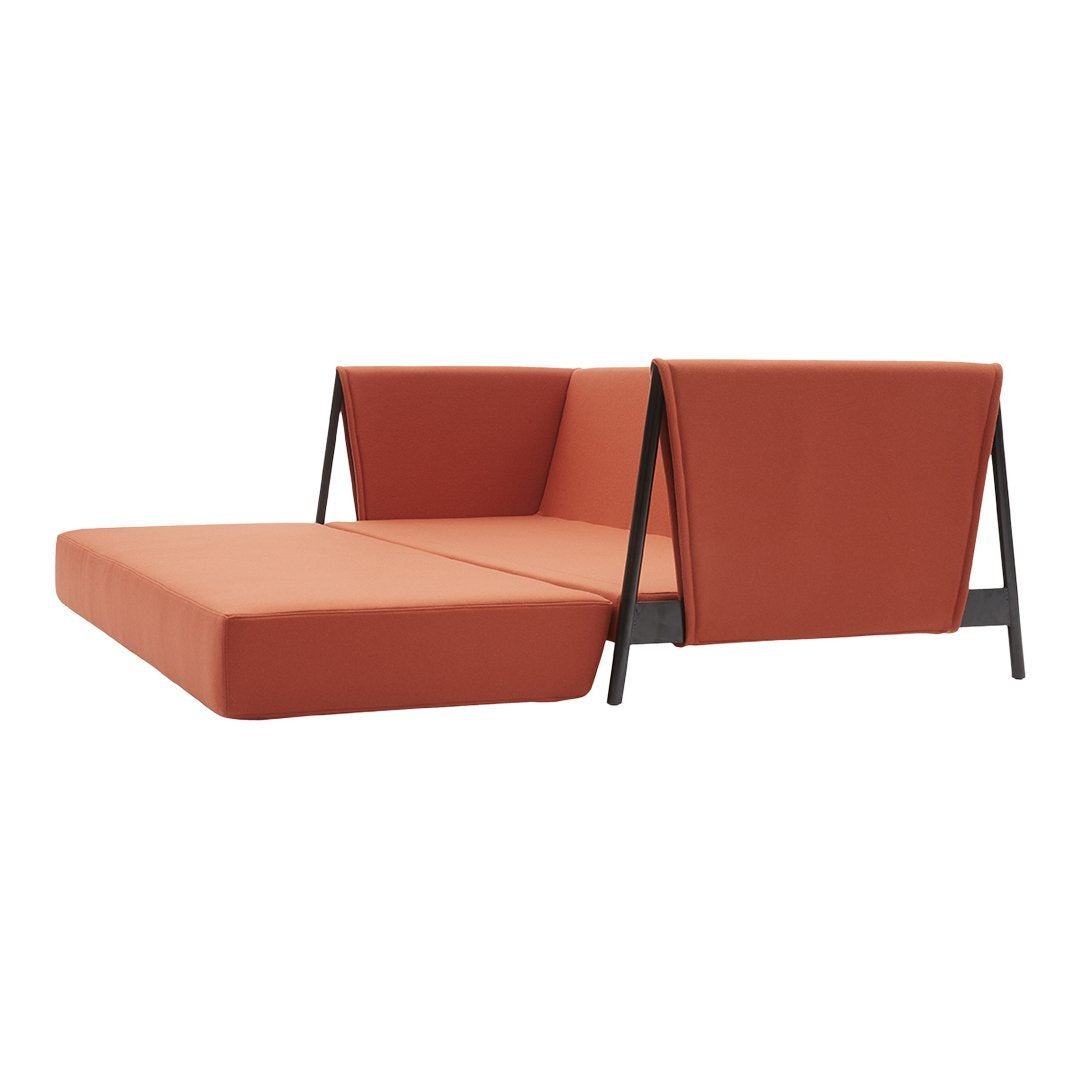Modern orange sofa with sleek black legs, featuring minimalist, geometric design; perfect for contemporary spaces.
