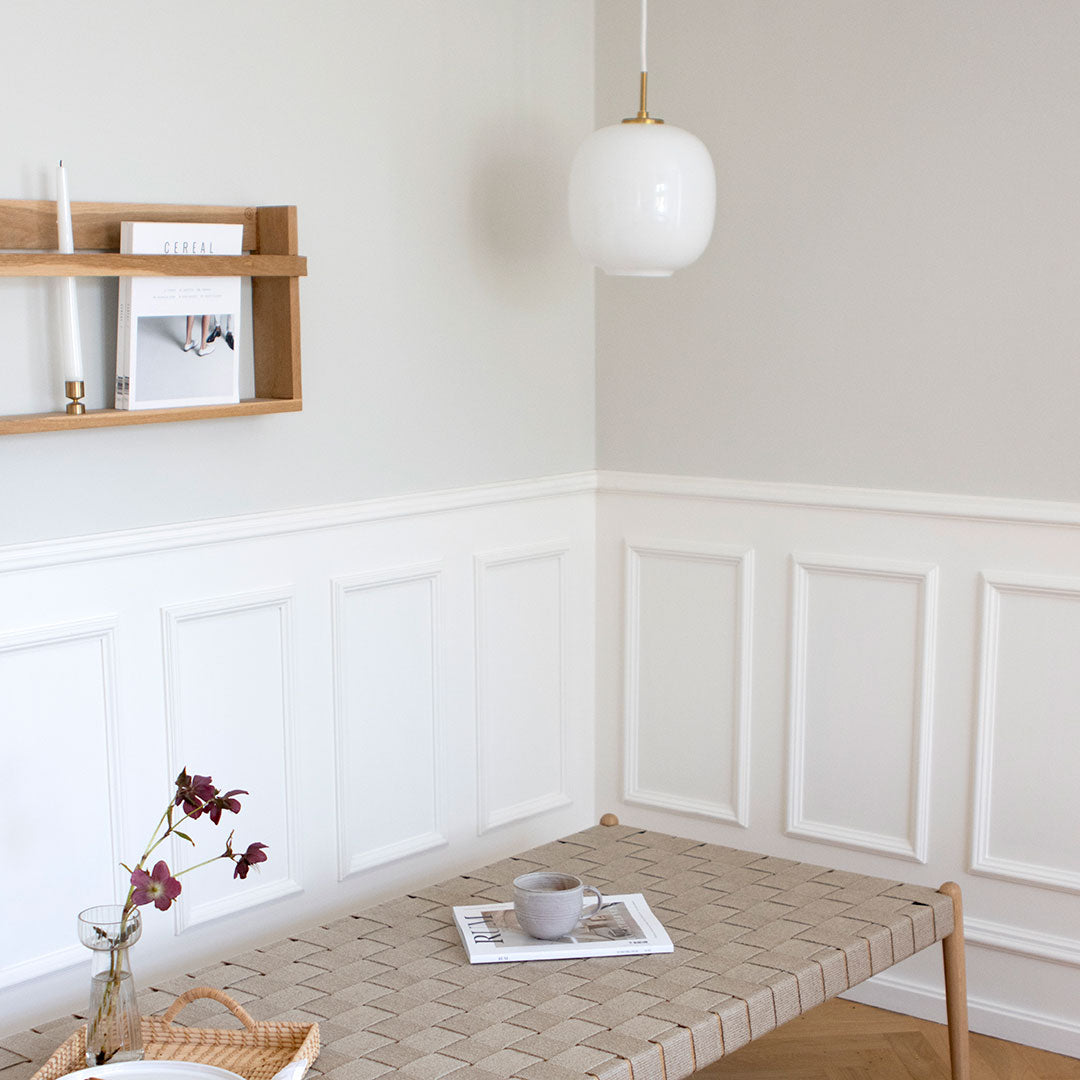 Patterned beige tabletop with subtle geometric design, white walls, and light wood accents for a modern aesthetic.
