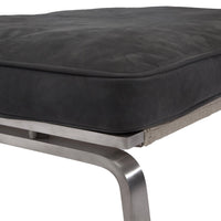 Black padded cushion with fabric texture on sleek metallic frame. Modern design with subtle detailing.