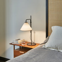 Modern black and white table lamp on wooden nightstand, featuring clean lines and minimalist design.