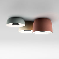Three modern ceiling lamps featuring teal, beige, and terracotta shades against a minimalist backdrop.