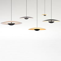 Modern pendant lights featuring a sleek design in black, gold, and white with circular patterns.