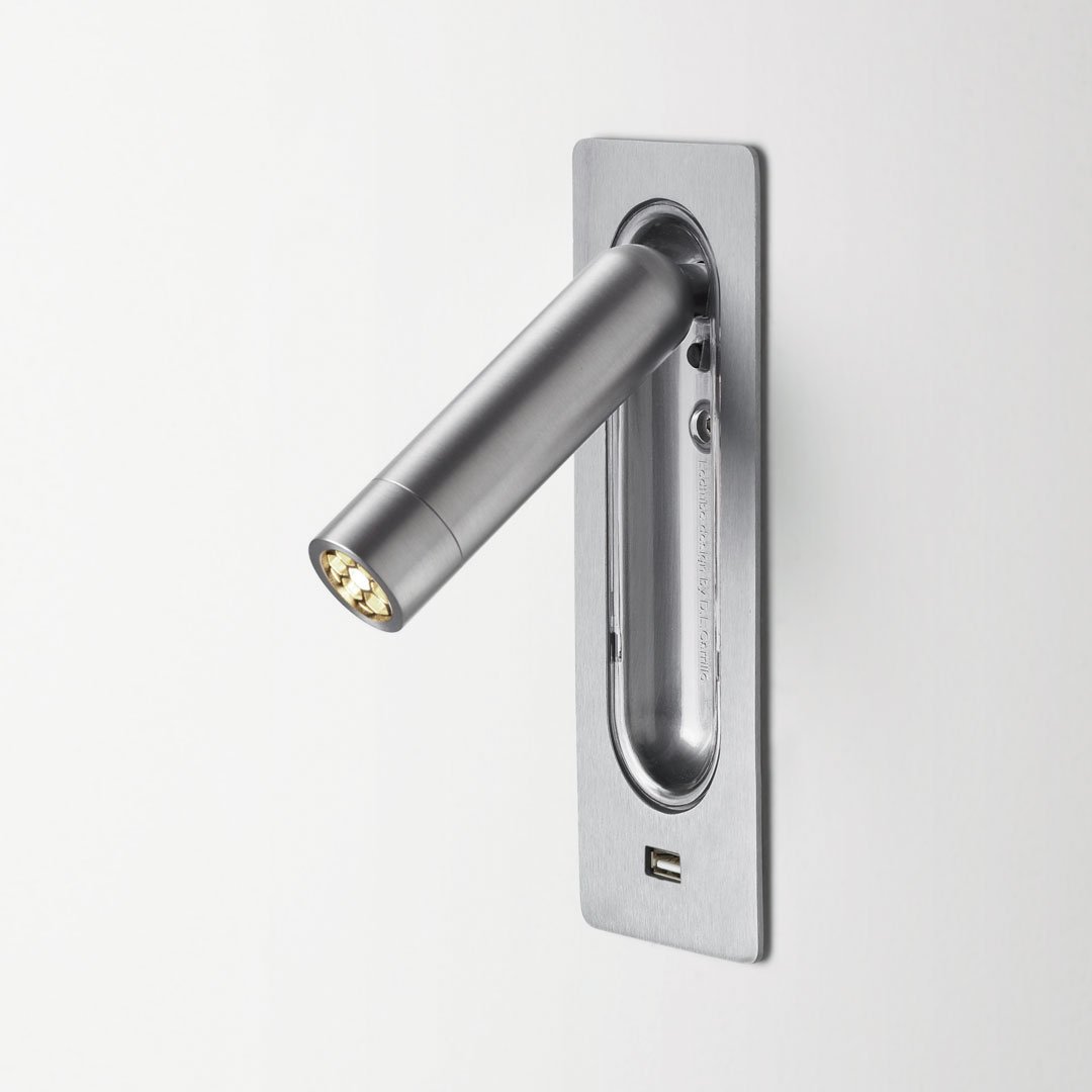 "Brushed silver wall-mounted reading light with sleek, modern design and minimalist pattern."