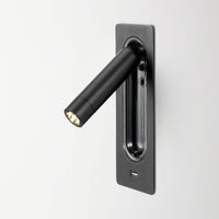 Black wall-mounted light fixture with sleek cylindrical design and subtle matte finish. Modern minimalistic style.