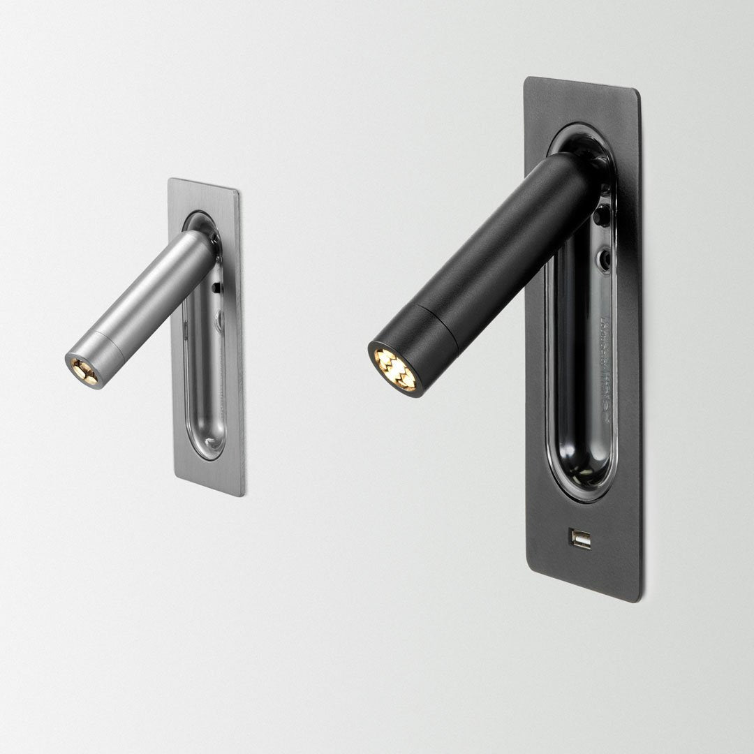 Two modern wall lights in sleek black and silver finishes, featuring minimalist design and geometric patterns.