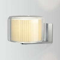 Modern wall lamp in clear glass with a textured cream shade and sleek chrome mounting, ideal for contemporary decor.
