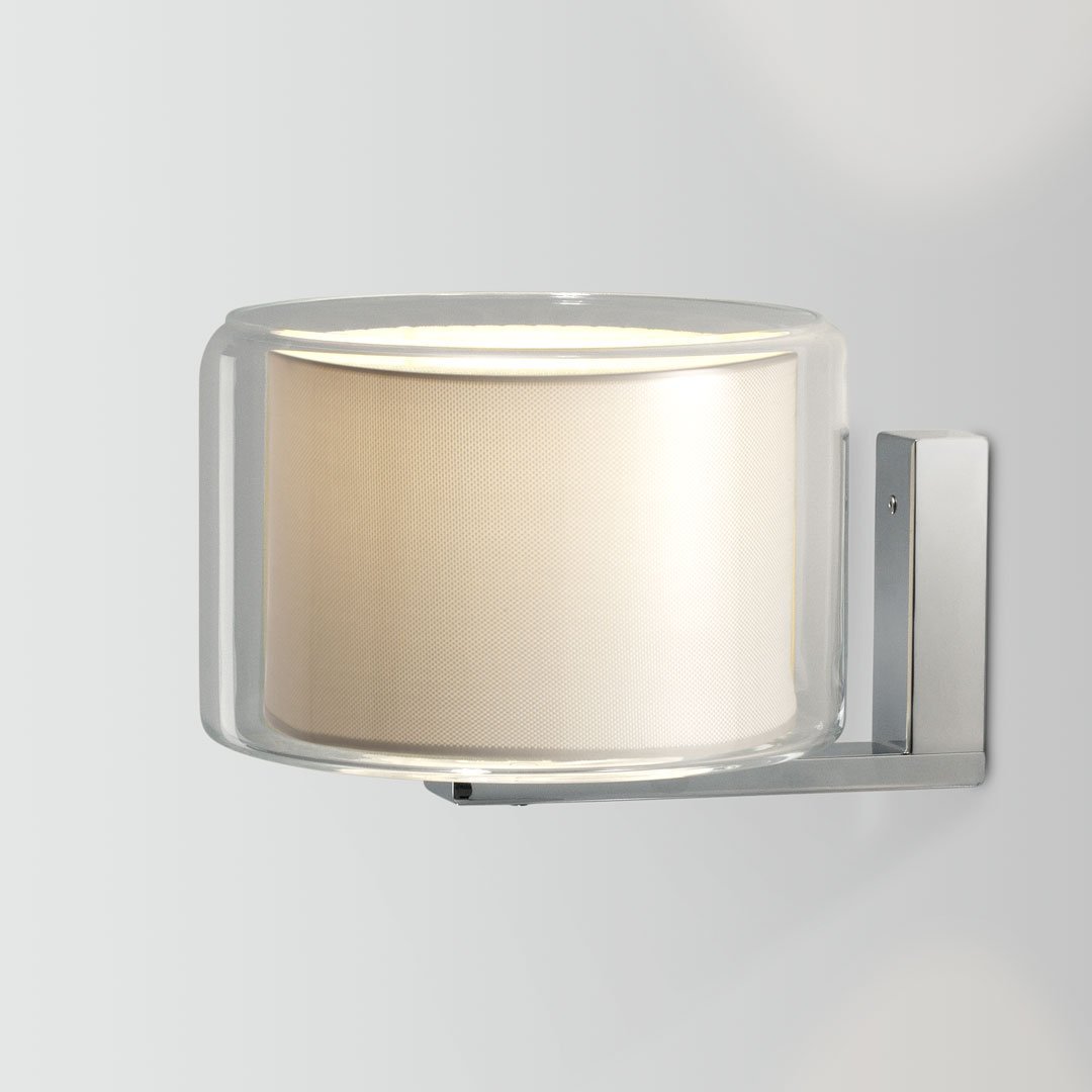 Transparent glass and soft beige lamp with polished chrome mount, offering a sleek, modern aesthetic.