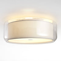Modern round ceiling light featuring a soft white fabric shade and transparent plastic rim, creating an elegant glow.