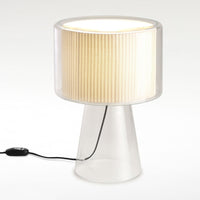 Clear lamp base with pleated cream shade, creating a soft glow and modern aesthetic. Perfect for any decor style.