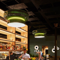 Green and white modern pendant lights with glossy finish, featuring sleek circular patterns against a dark backdrop.