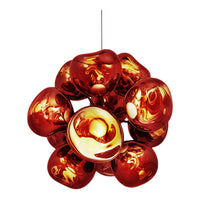 Glossy amber and red pendant light with a playful, organic shape and reflective surfaces. Modern design accent piece.