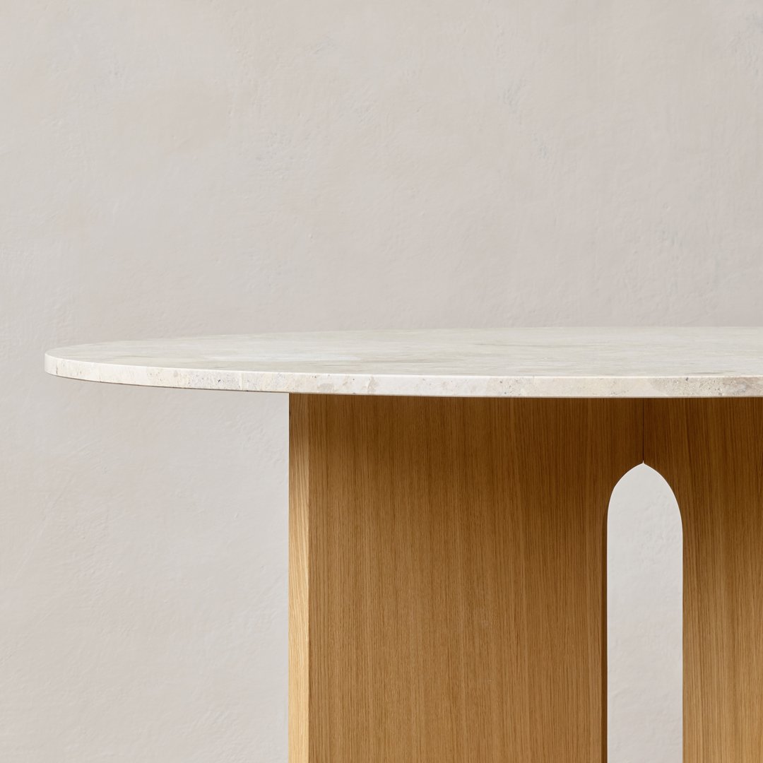 Round white marble tabletop with natural wood base featuring a minimalist design and soft, neutral colors.