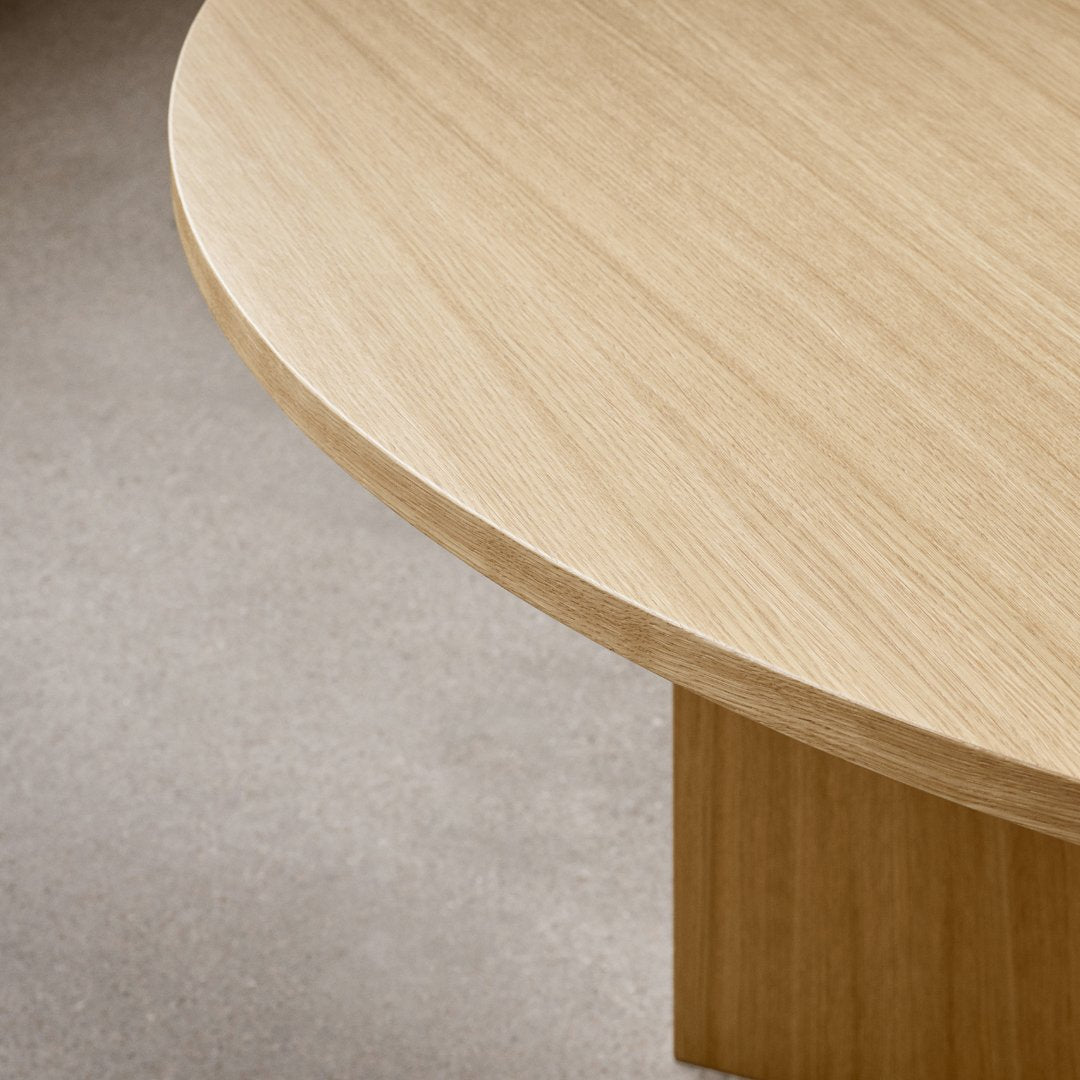 "Light wood grain finish with a smooth, rounded edge texture on a minimalist table."