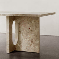 Elegant beige table with subtle stone patterns and a minimalist design, featuring a unique cut-out detail.