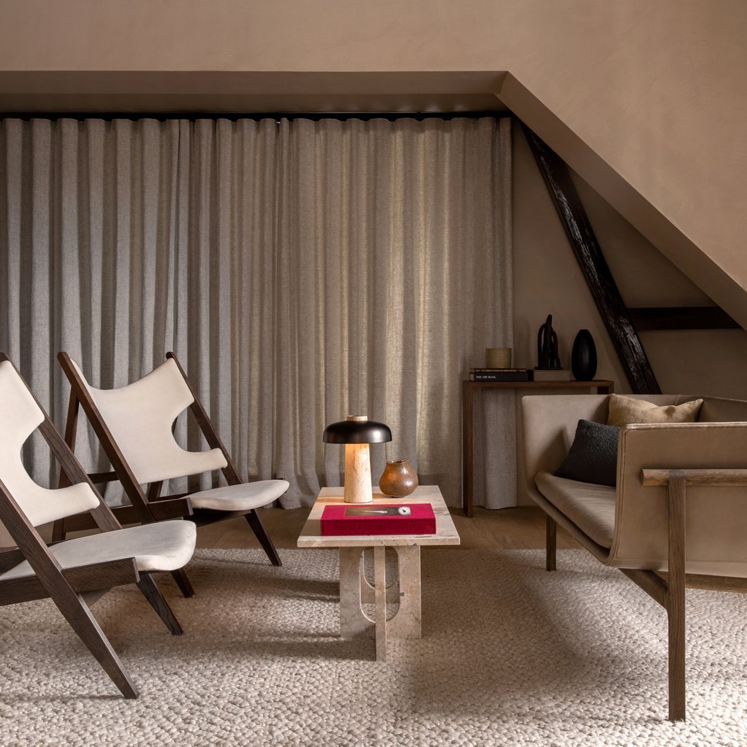 "Neutral tones with textured curtains, beige furniture, and minimalist patterns create a modern, inviting living space."