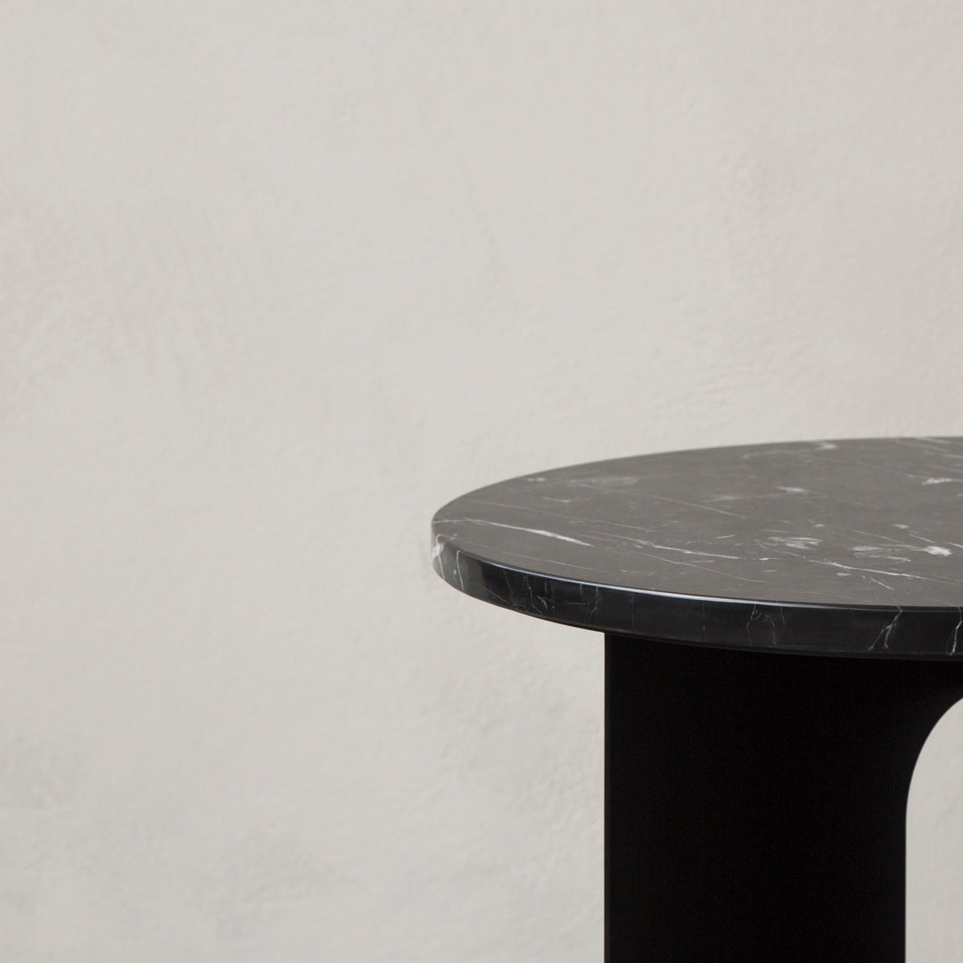 Black marble tabletop with subtle white veining, paired with a sleek black base. Modern and elegant design.