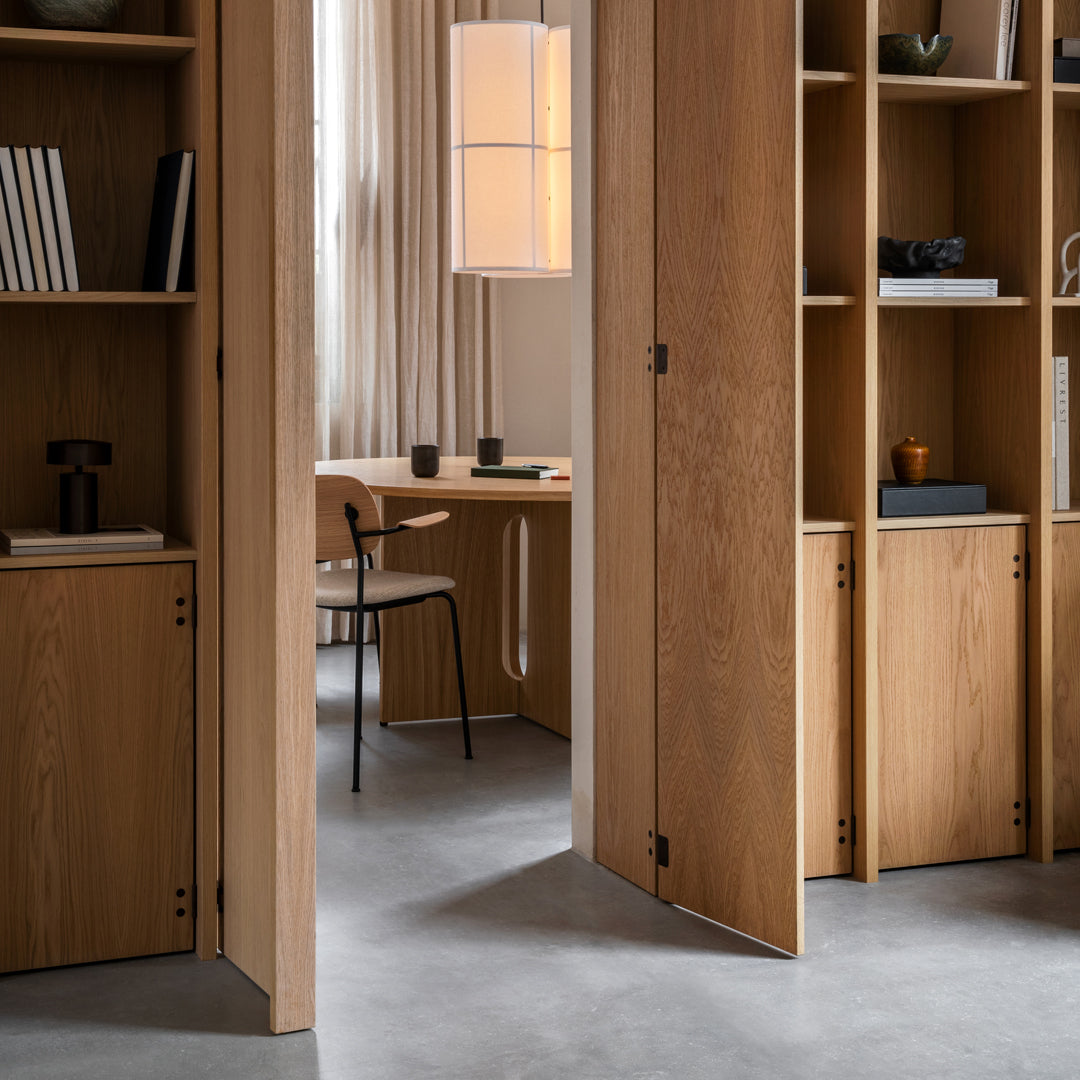 Light oak wood shelving with minimalist design, featuring smooth lines and a neutral color palette in a modern office setting.