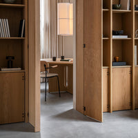 Light oak wood shelving with minimalist design, featuring smooth lines and a neutral color palette in a modern office setting.