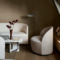Neutral beige and white tones with smooth textures in a modern living room setting, featuring curved furniture.