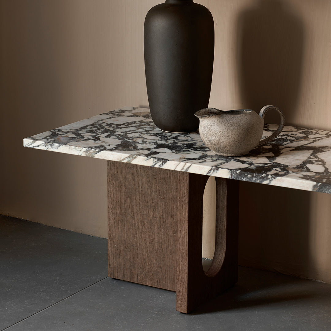 Abstract black and white marble tabletop with a rich brown base, featuring a smooth texture and elegant patterns.