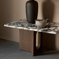 Abstract black and white marble tabletop with a rich brown base, featuring a smooth texture and elegant patterns.