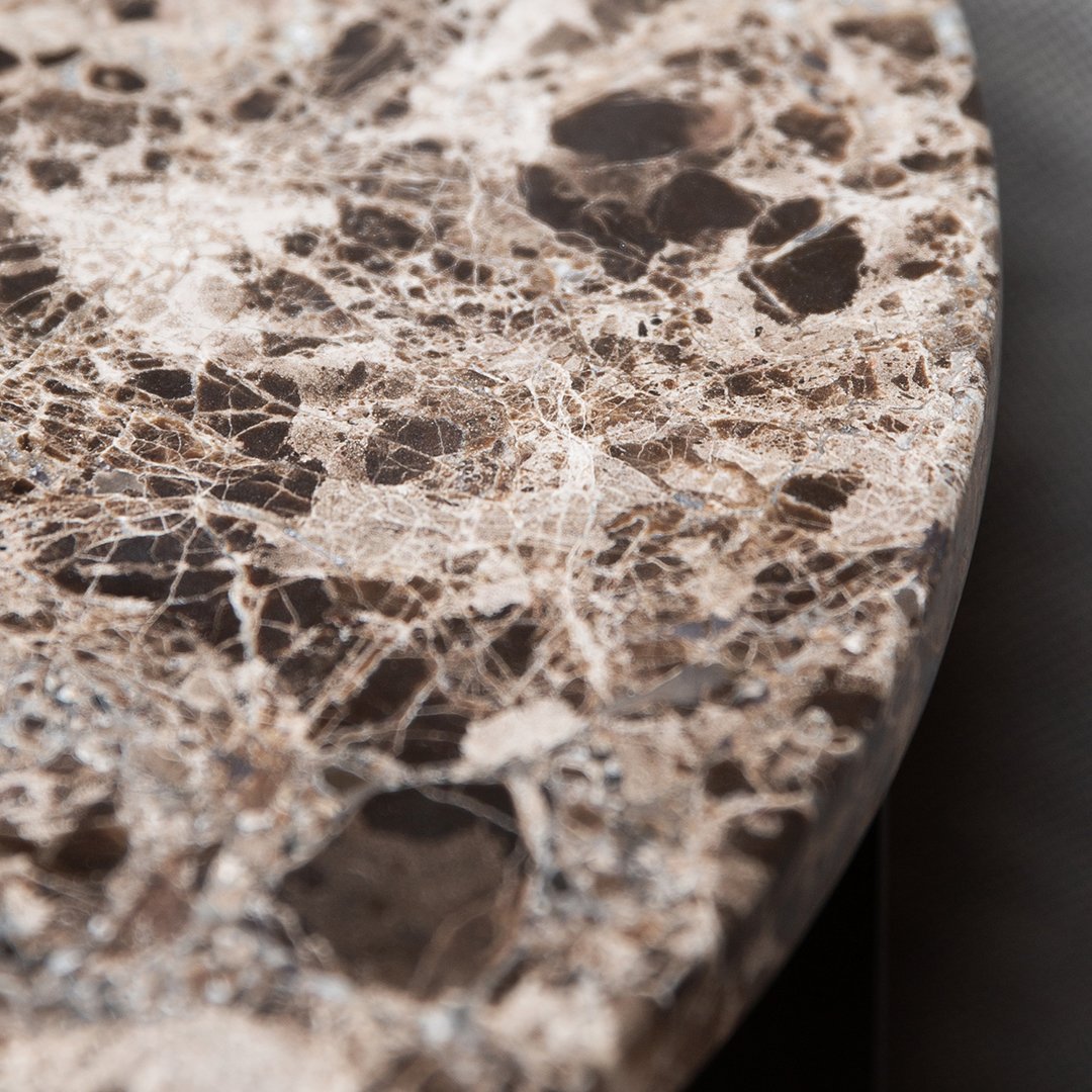 Brown marble tabletop featuring intricate veining and a polished surface with varied stone patterns.