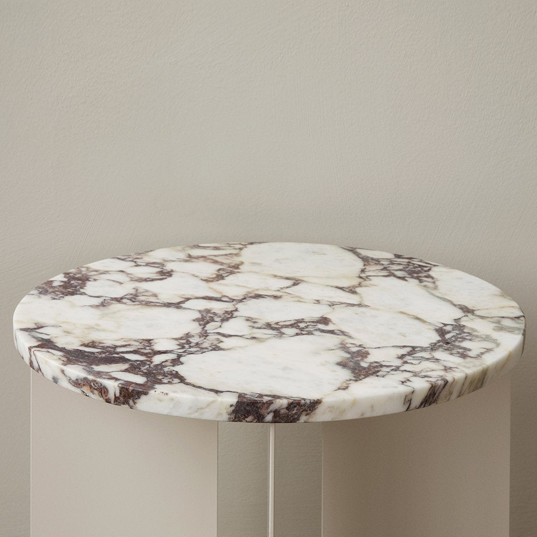 Round marble tabletop featuring a white base with brown veining and intricate patterns, ideal for modern decor.