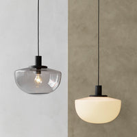 Modern pendant light featuring clear and frosted glass shades with black metal accents. Stylish and versatile design.