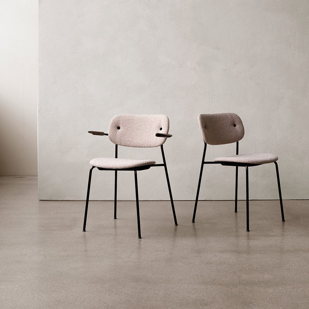 Pink and taupe chairs with sleek black legs, featuring minimalist designs and subtle texture. Ideal for modern décor.