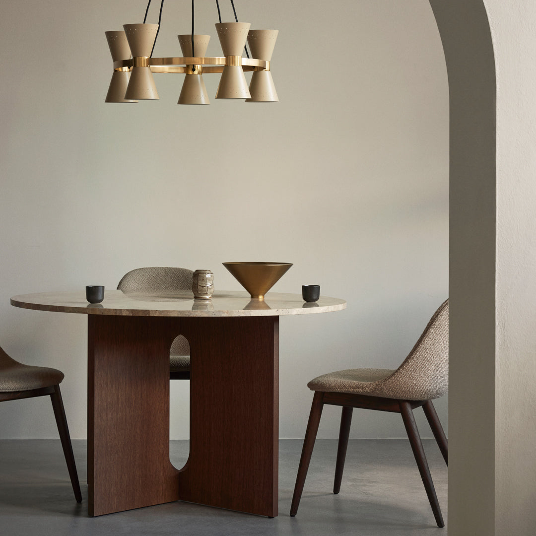Modern dining set featuring a round marble table, warm wood tones, and gold accents with neutral color palette and subtle textures.