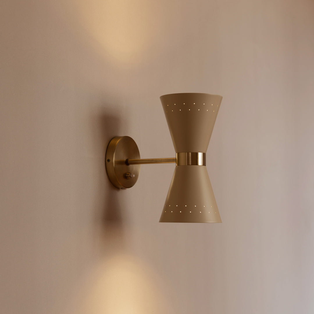 Beige wall sconce with a unique bow tie shape and decorative perforated pattern, highlighting modern elegance.
