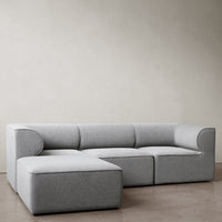 Gray modular sofa with a sleek, minimal design and smooth fabric texture, ideal for modern living spaces.
