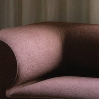 Textured upholstery in warm mauve tones, showcasing a sophisticated, modern design. Ideal for stylish interiors.