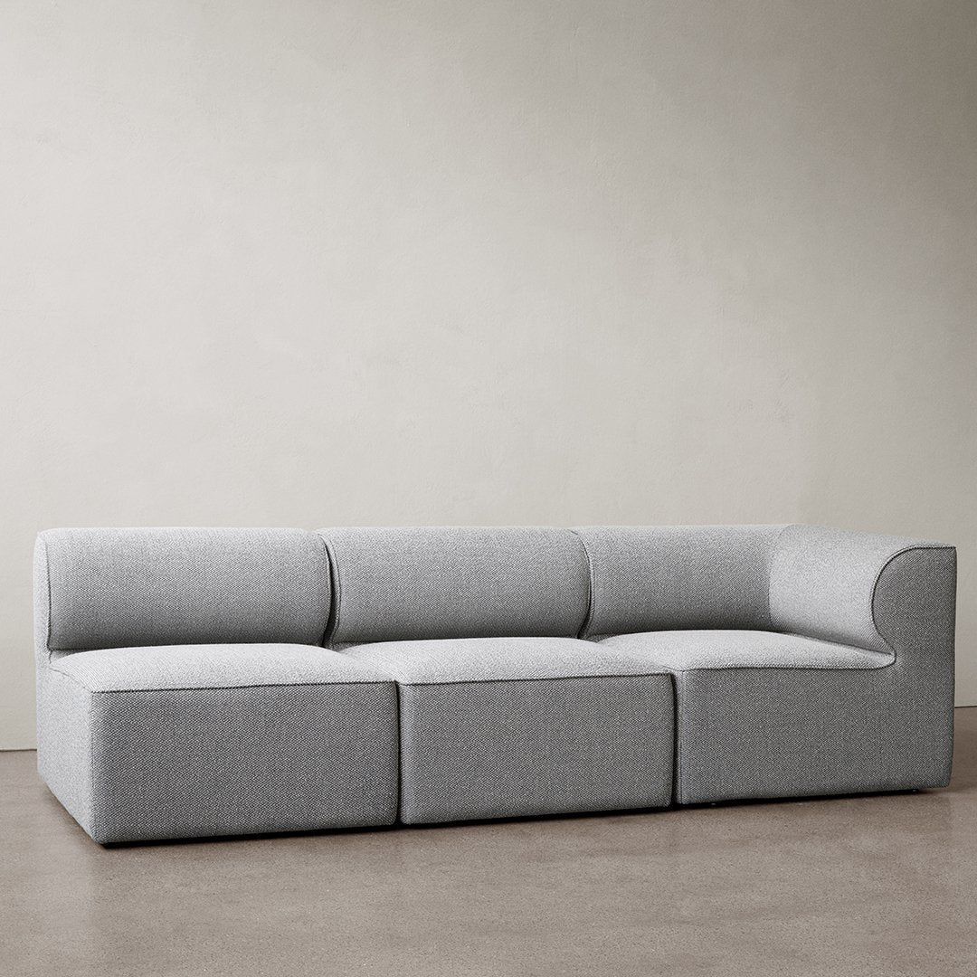 Modern gray sectional sofa with a sleek, minimalist design and soft fabric upholstery, perfect for contemporary spaces.