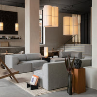 "Modern gray sectional sofa with minimalist design in a stylish interior featuring warm tones and soft lighting."