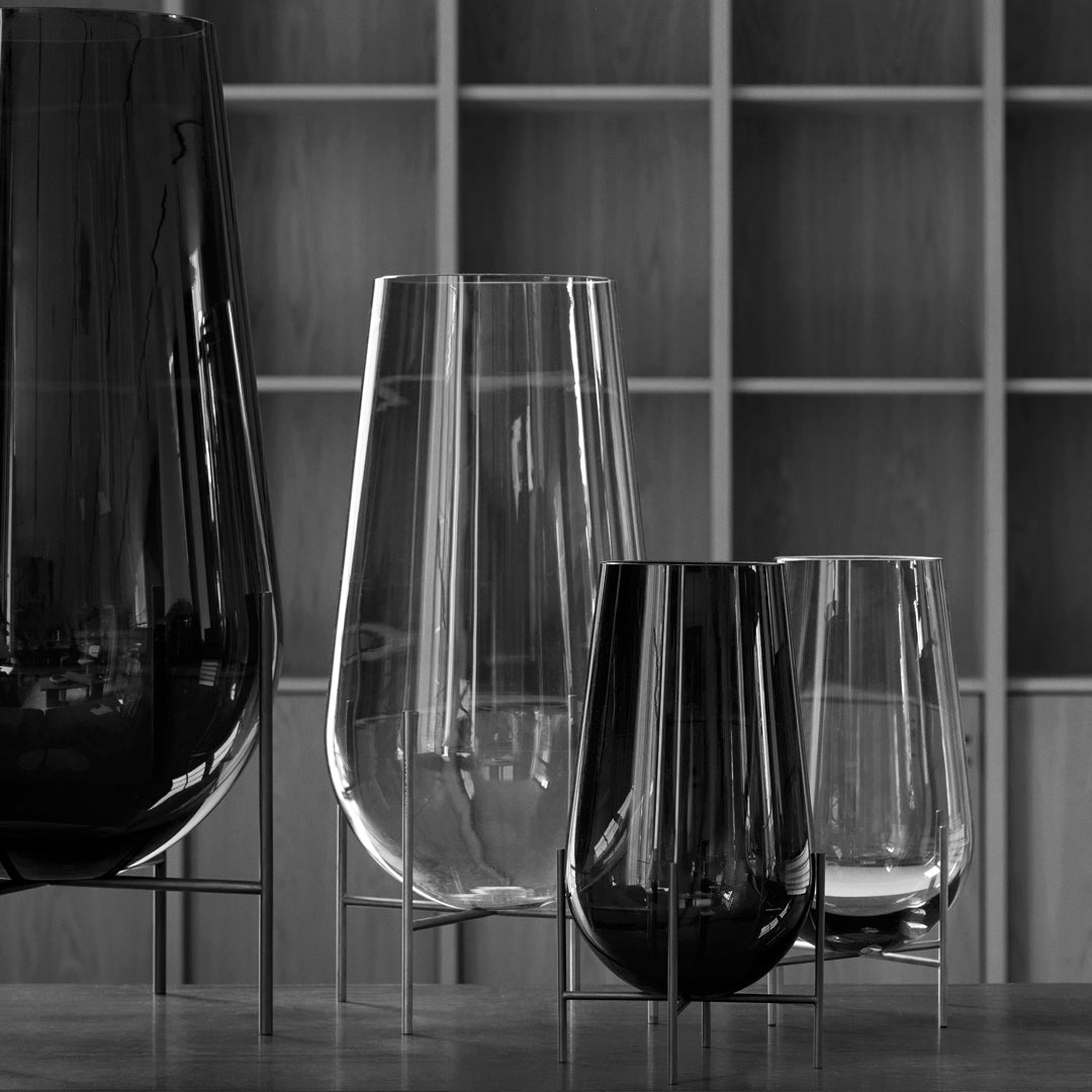Set of elegant glass vases in varying heights, featuring sleek black and clear finishes with a modern design.
