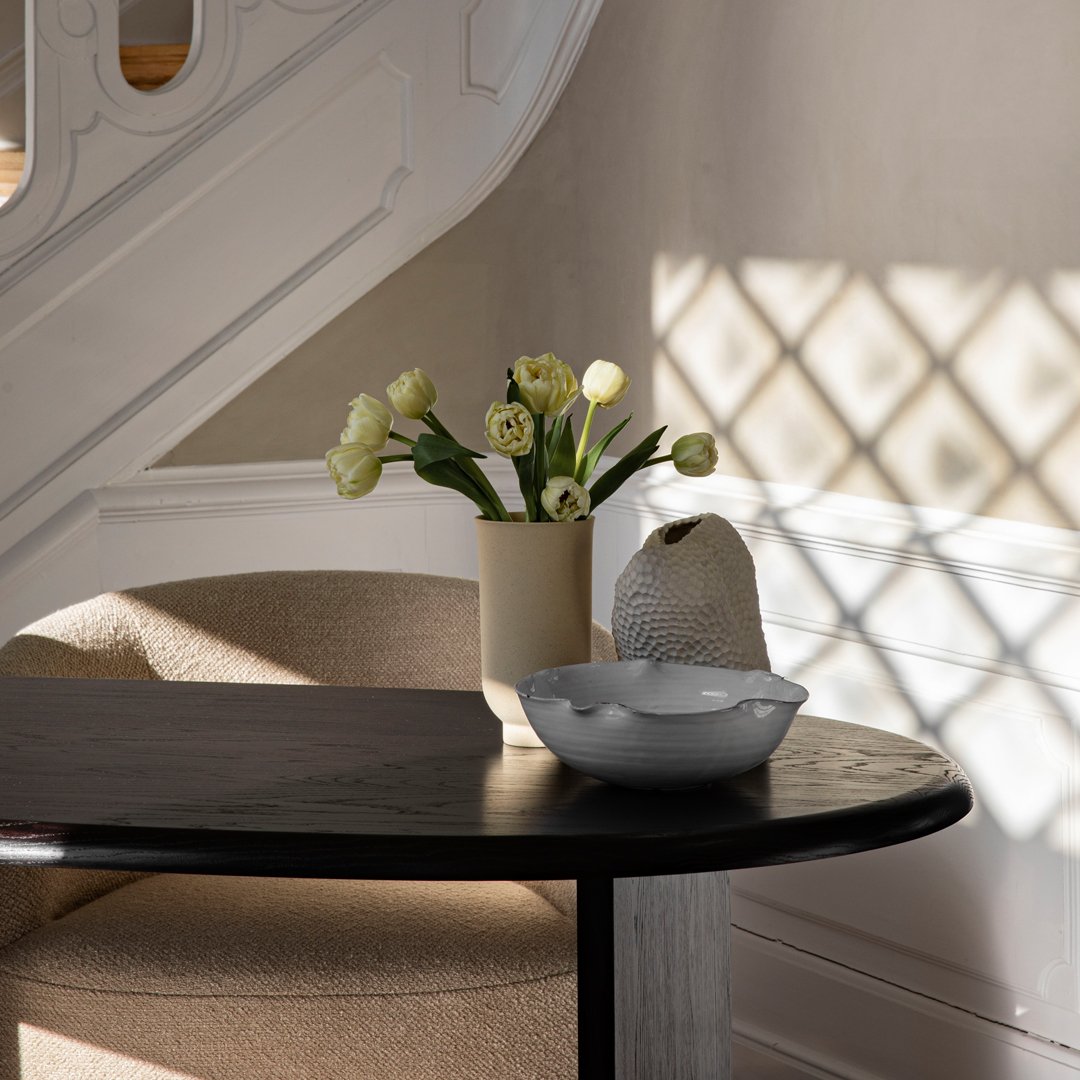 "Neutral beige and soft gray tones with delicate yellow floral accents in a modern, cozy setting."