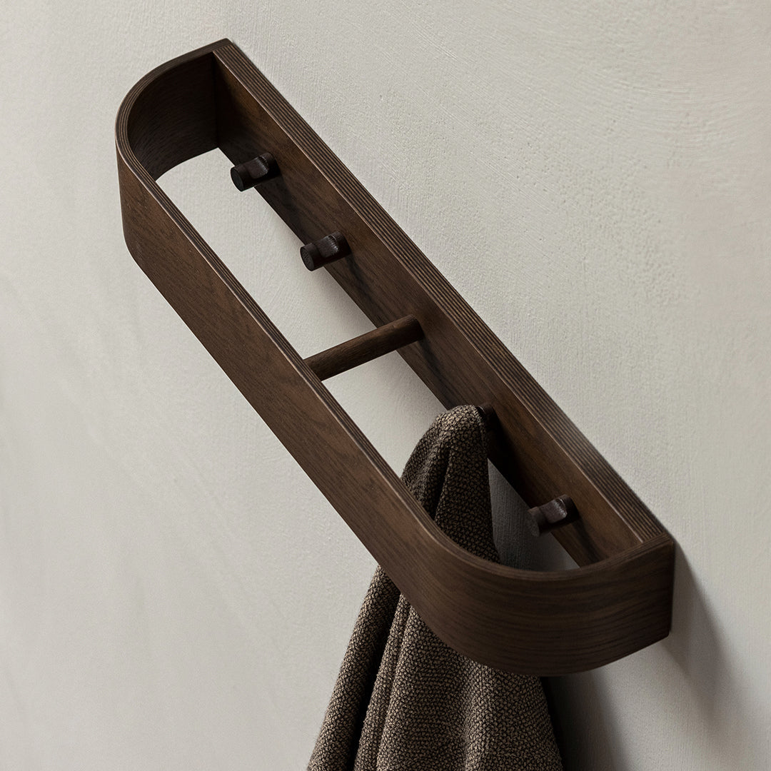 Dark wooden towel bar with smooth, rounded edges, featuring a minimalist design and rich brown finish.
